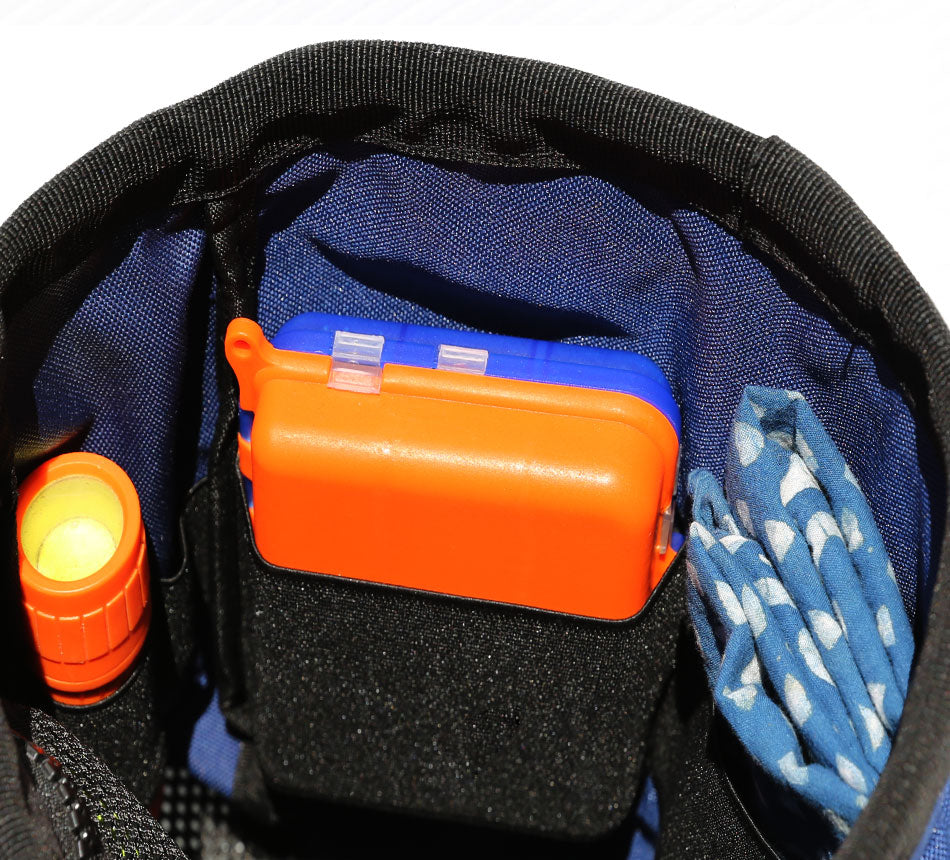 Milbea "ROOK" metal detecting finds bag in Navy with interior elastic straps holding a small flash light and coin pod.